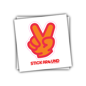 A Kiss Cut Sticker design featuring an orange hand making the peace sign with two fingers raised, outlined in red and pink. Below the hand is the text "STICKAROUND" in bold, red letters. The custom vinyl sticker design is placed on a white square background.